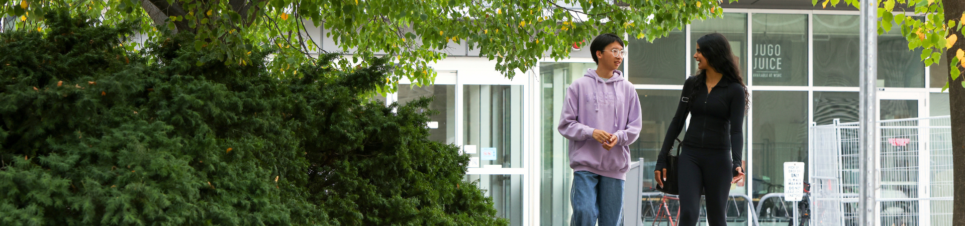 Two students walk outside.