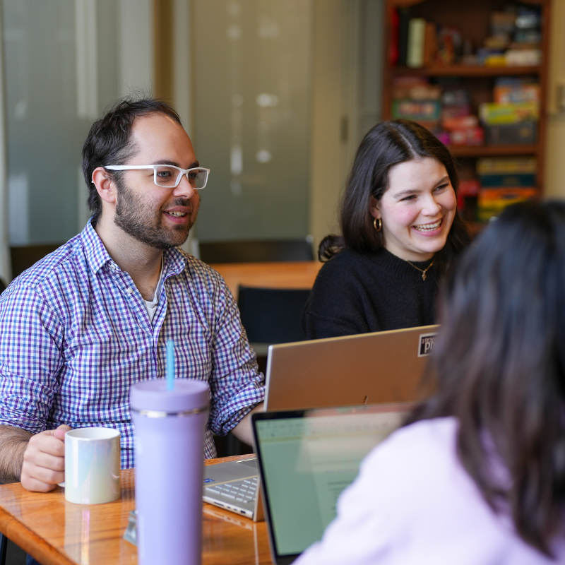 Graduate students meet at a restaurant for conversation.