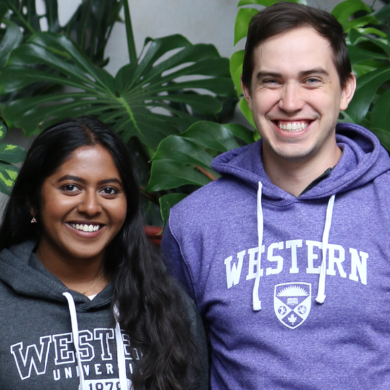 Two students dressed in Western University sweaters.