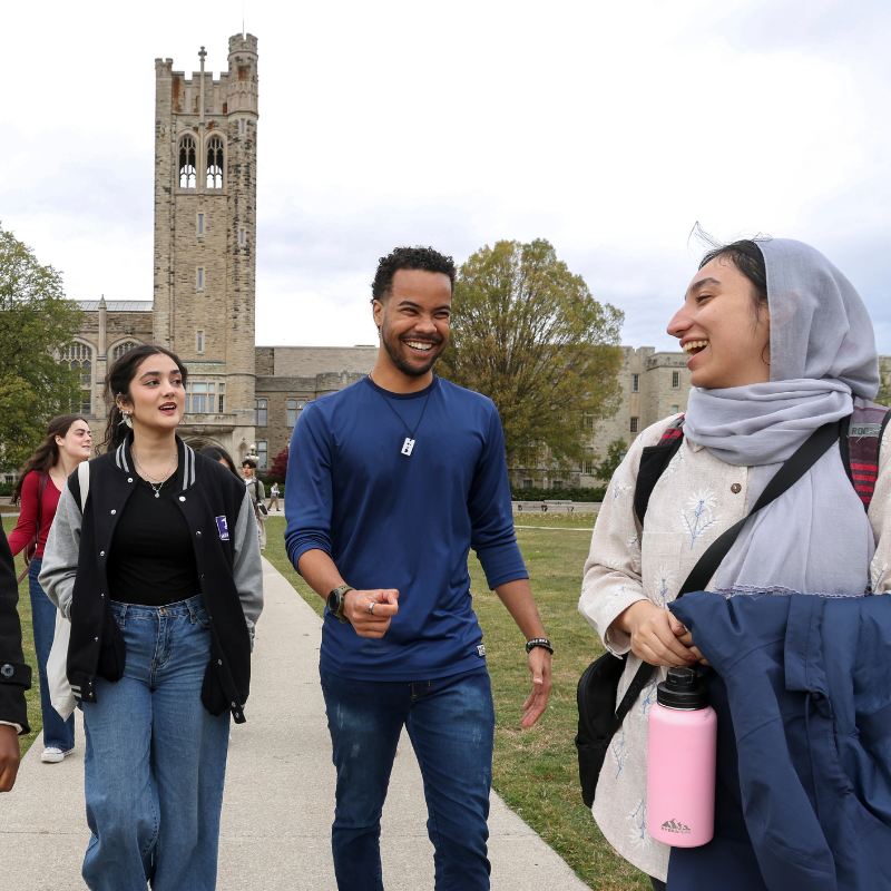 Several students walk around outside.