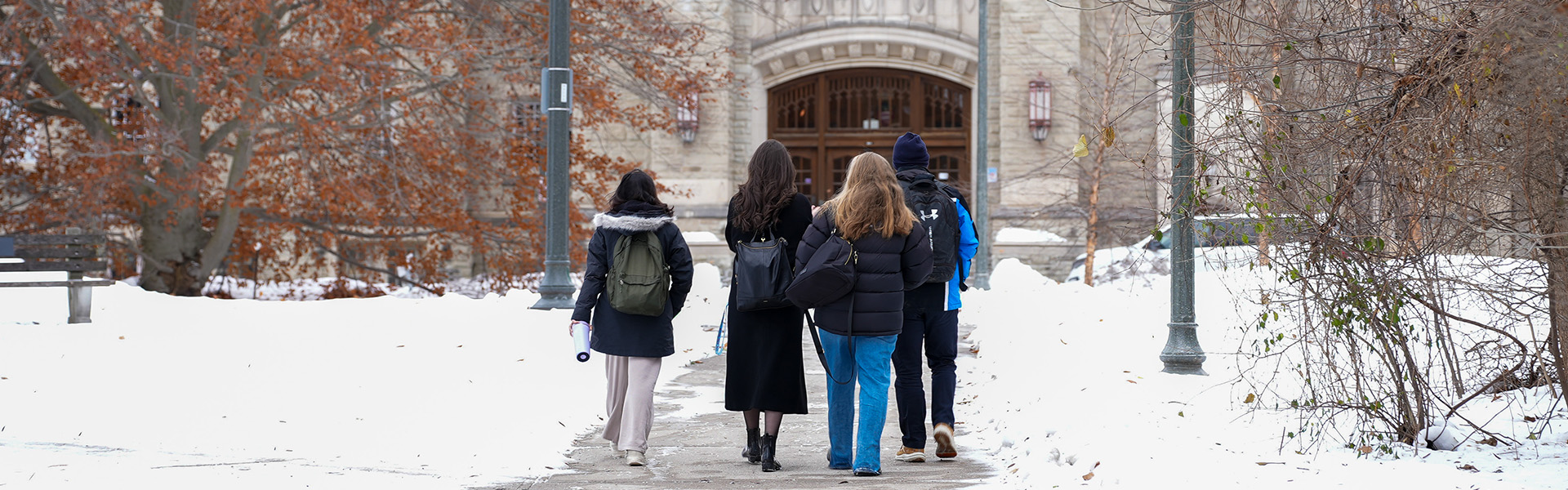 Four students walking on campus